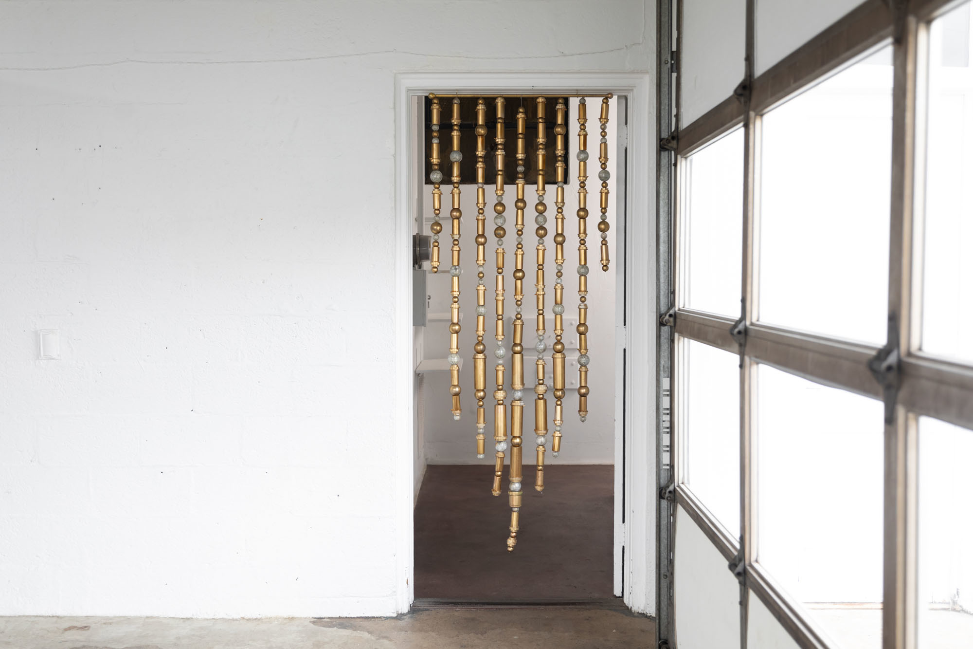 Jocelyn Mathewes, Medicine Threshold, 2020-2021, sculptural curtain made of prescription medicine bottles, shredded money, gold paint, metallic fibers, vending machine balls, 36” x 72” Jocelyn Mathewes, Medicine Threshold, 2020-2021, sculptural curtain made of prescription medicine bottles, shredded money, gold paint, metallic fibers, vending machine balls, 36” x 72”
