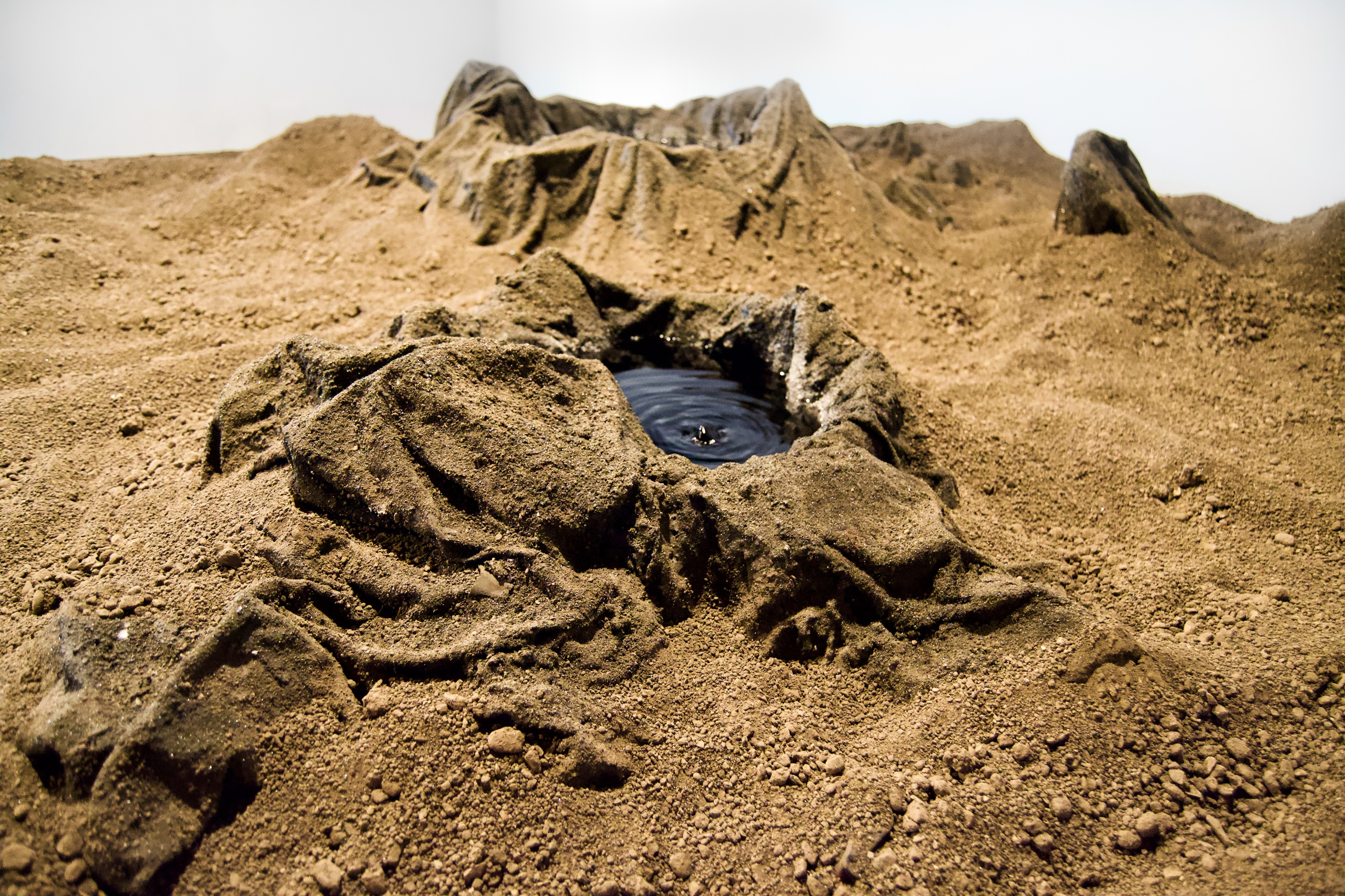 Caroline Hatfield, Land and Water, 2019, 45" x 144" x 96”, mortar stands, plywood, crushed recycled concrete, resin bonded concrete, aluminum, dyed water, water pumps [detail]