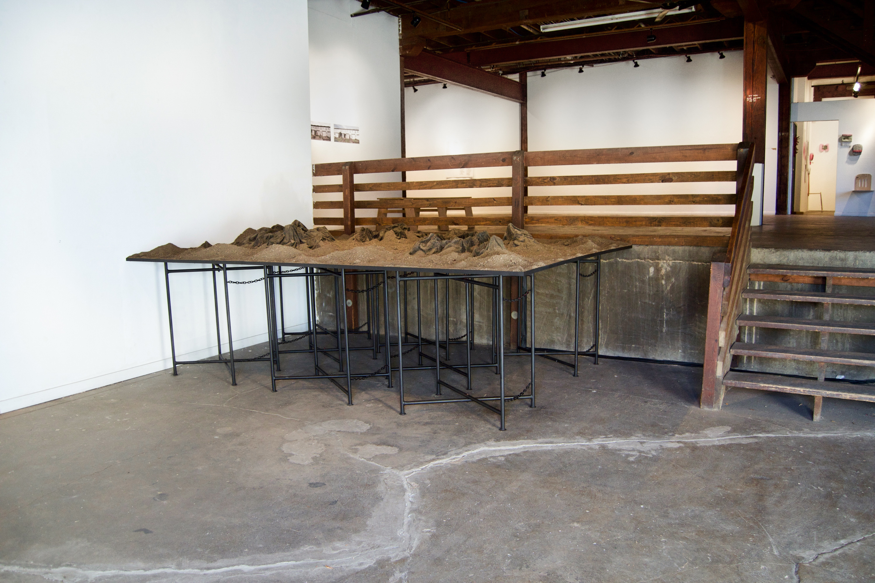 Caroline Hatfield, Land and Water, 2019, 45" x 144" x 96”, mortar stands, plywood, crushed recycled concrete, resin bonded concrete, aluminum, dyed water, water pumps