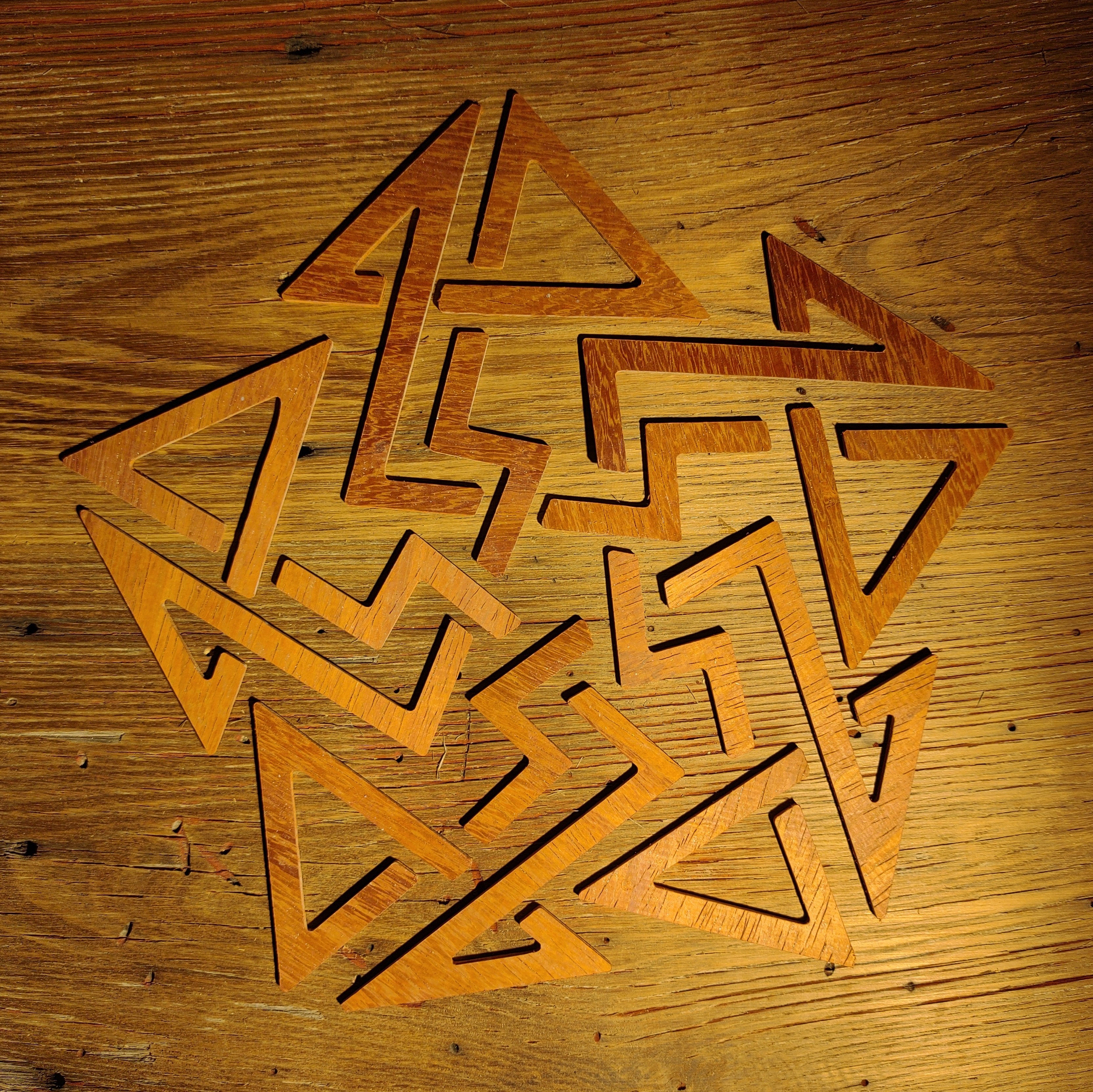 Adam Rowe, "unicursal pentad knot", wood (padauk, barn board), 16.5" square 