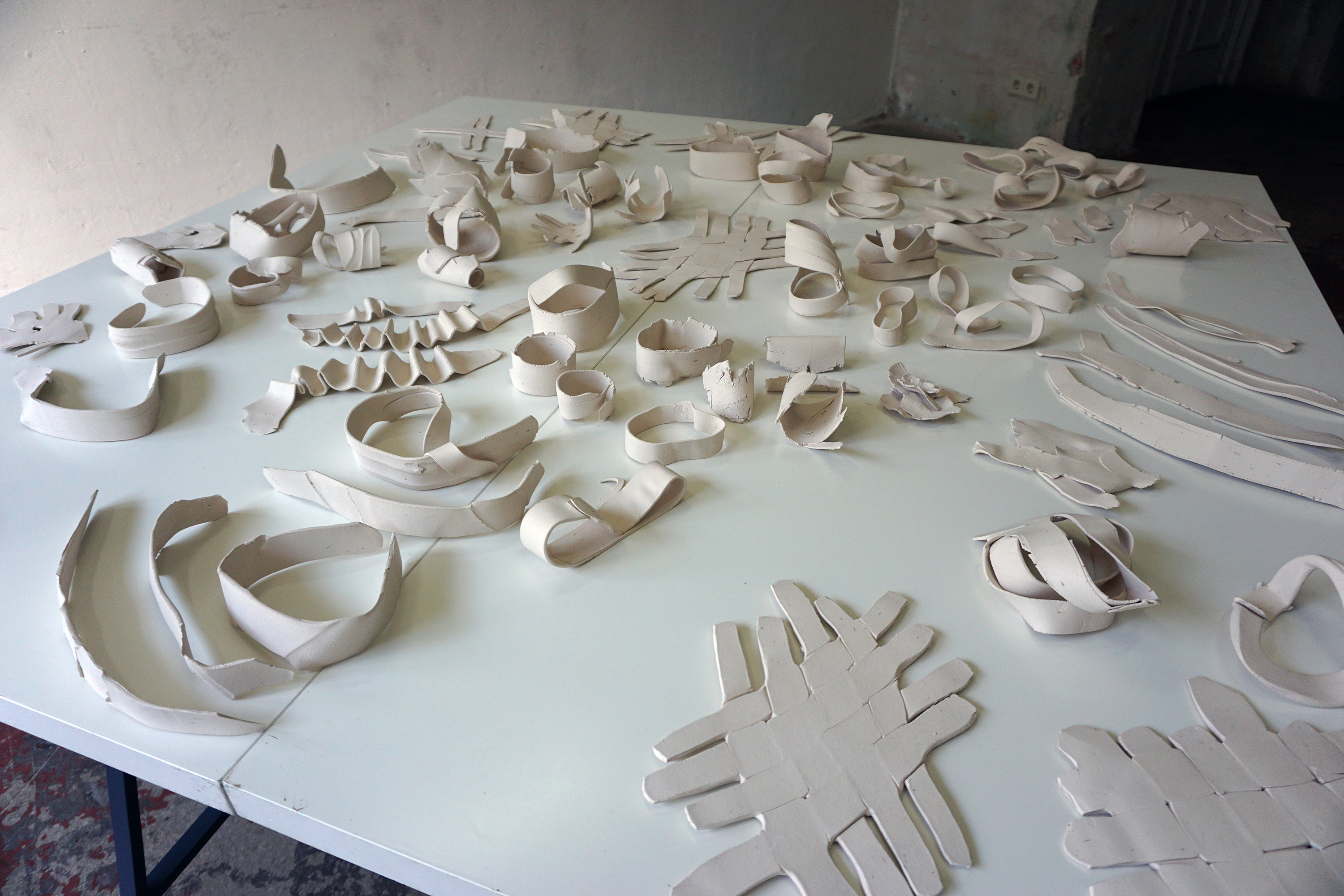 Jennifer Danos, On the Ideology of Fieldwork, 2016, Installation and detail views, Fired, unglazed white clay on tables, Dimensions variable, from Fieldwork: Berlin Summer Salon